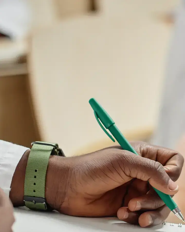 a person is writing on a piece of paper