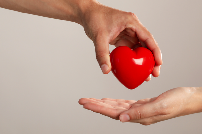 red-heart-being-handed-to-a-different-person