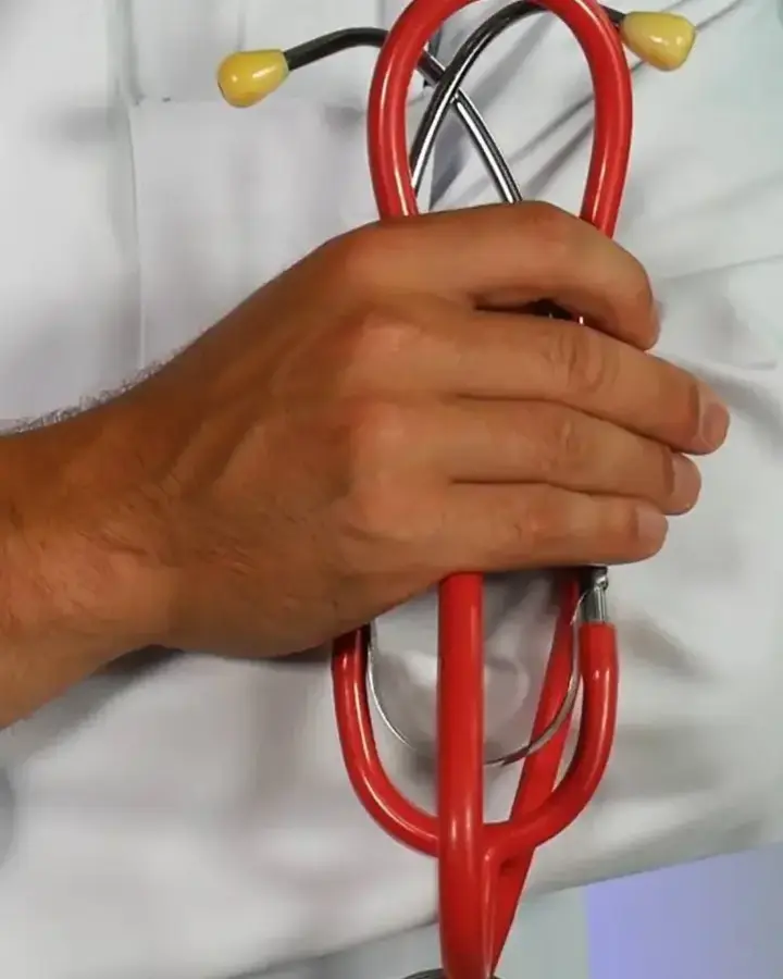 a doctor holding a stethoscope with his arms crossed