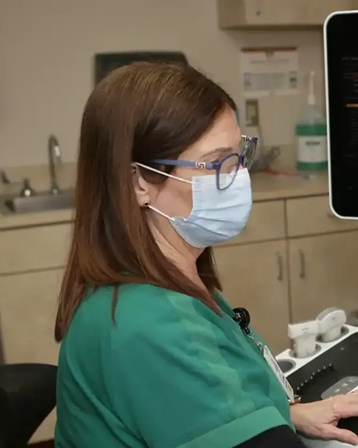 nurse in mask at desk 