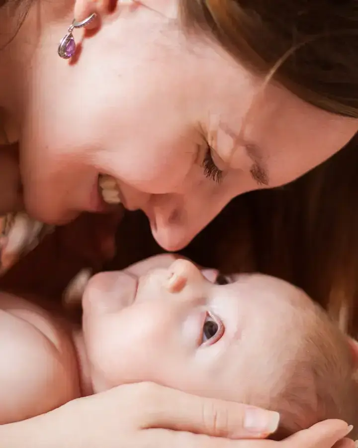 a woman holding a baby in her arms