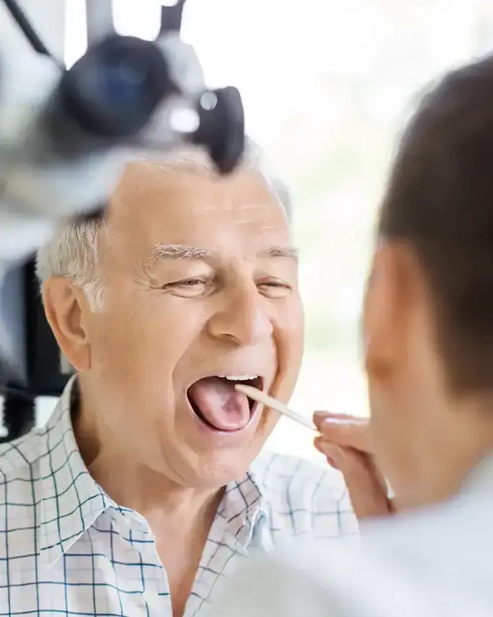 doctor checking patient's throat