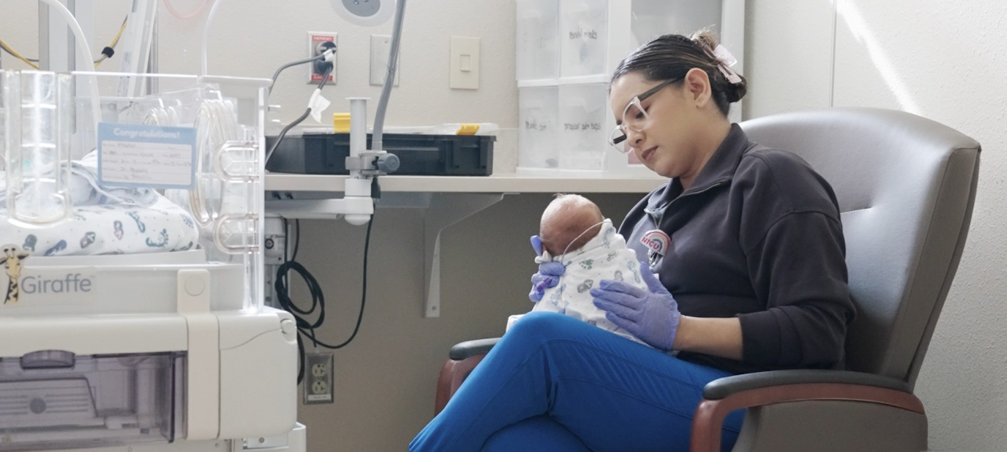 NICU-Nurse-sitting-holding-a-small-baby