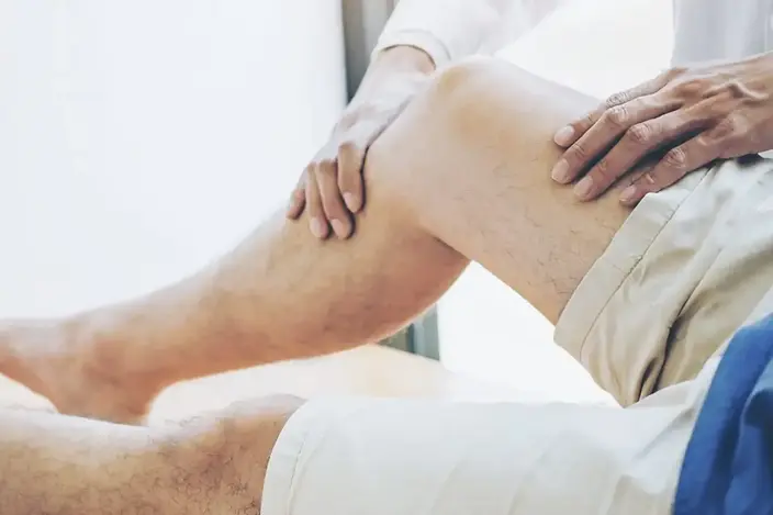 man on table getting leg exam