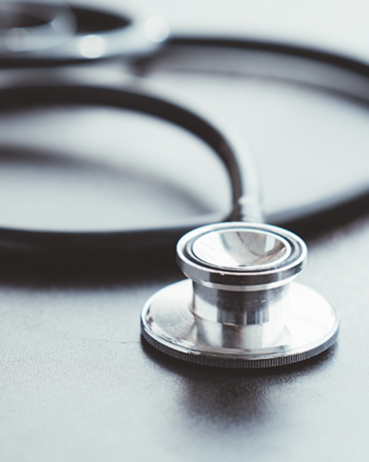 stethoscope-and-pen-on-a-dark-table