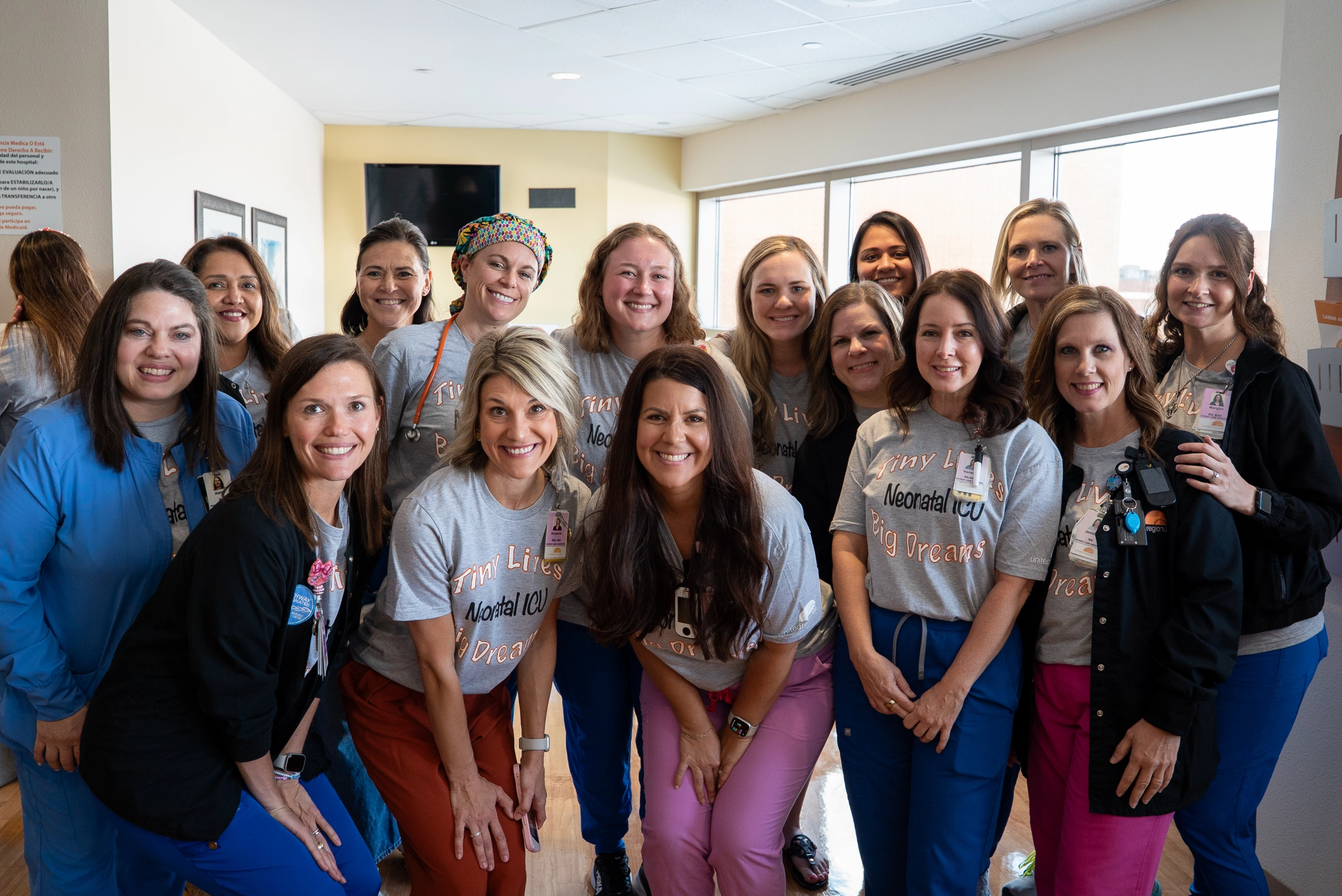NICU staff group-of-women-wearing-scrubs-and-smiling