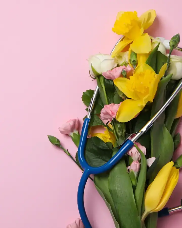 a bouquet of flowers with a stel on a pink background