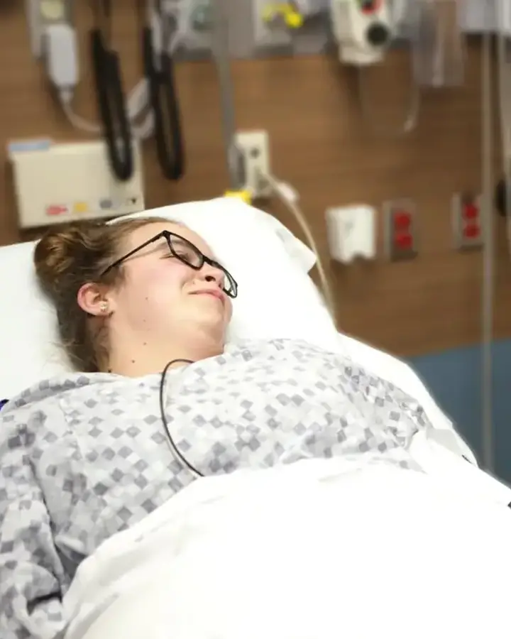 woman in hospital bed talking to nurse